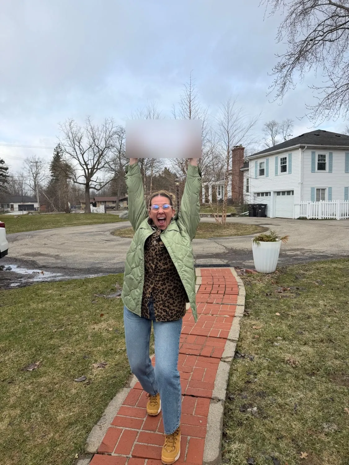 A VFO petition circulator cheering with a completed petition held overhead on a front walkway.
